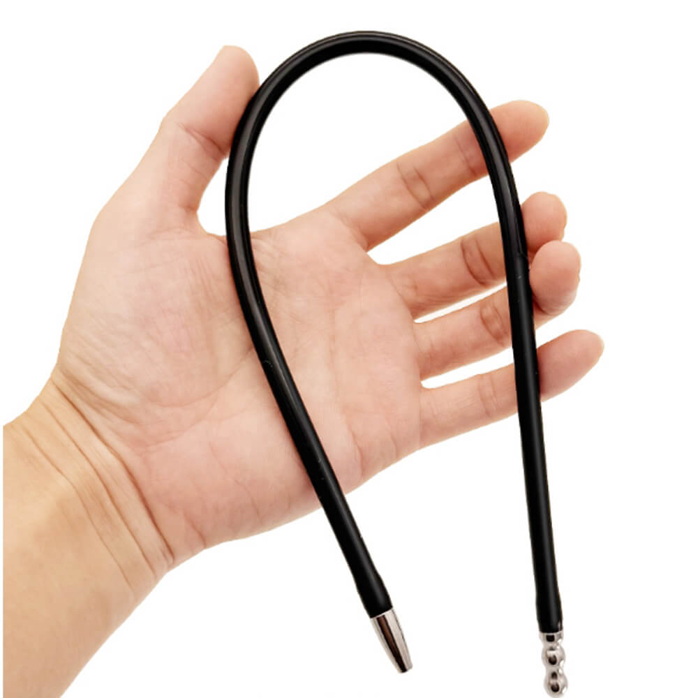 Maparon 23 inch double ended silicone penis plug held in hand against a white background.