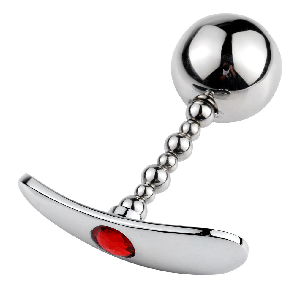 Side view of metal diamond butt plug with anchor base design displayed on white background, showing gemstone detail at the base.
